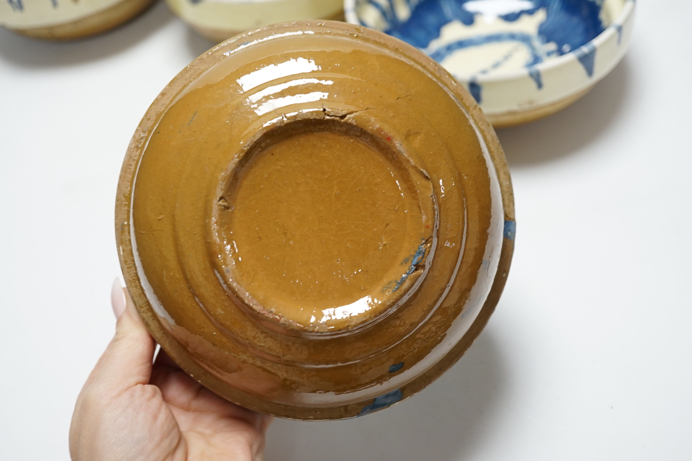 A group of six slipware pottery bowls, 16cm